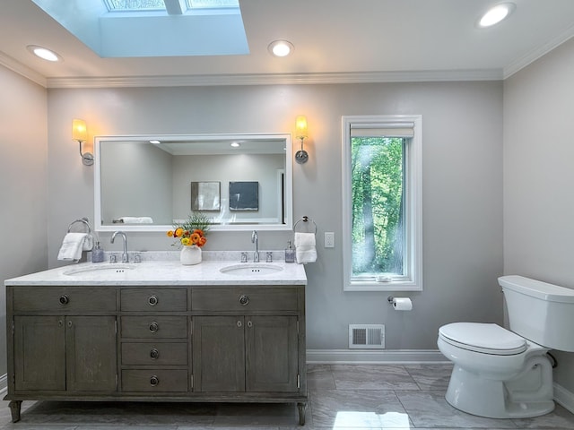 14700 Minnehaha Pl, Minnetonka, MN 55391 - bathroom with a skylight, toilet, baseboards, ornamental molding, and marble look tile flooring