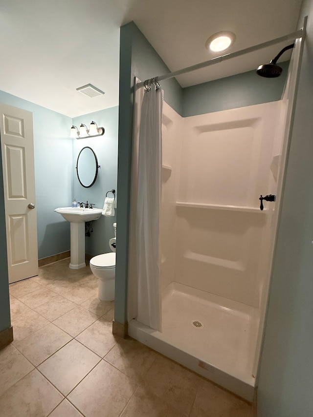 14700 Minnehaha Pl, Minnetonka, MN 55391 - bathroom with a shower stall, tile patterned flooring, toilet, and baseboards