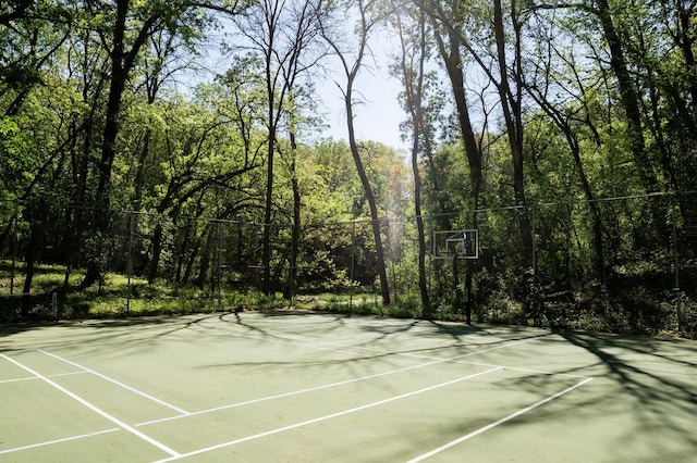 14700 Minnehaha Pl, Minnetonka, MN 55391 - view of tennis court with a wooded view and community basketball court