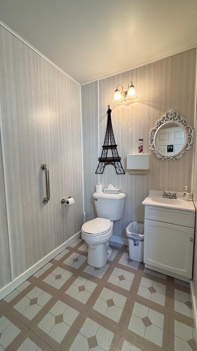 211 1st Ave, Osakis, MN 56360 - half bathroom with toilet, vanity, and tile patterned floors
