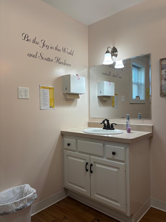 211 1st Ave, Osakis, MN 56360 - bathroom with wood finished floors, vanity, and baseboards
