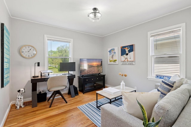 living room featuring light wood-style flooring, a desk, and baseboards