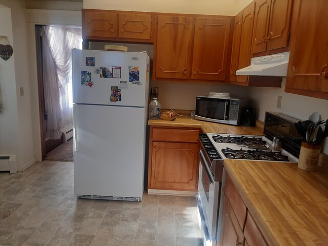 101 8th Ave N, Saint James, MN 56081 - kitchen with freestanding refrigerator, gas range, stainless steel microwave, under cabinet range hood, and a baseboard heating unit