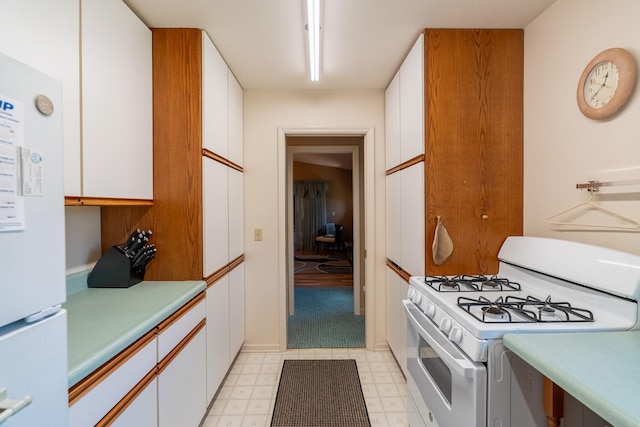 402 2nd Ave SE, Mapleton, MN 56065 - kitchen with white appliances, light countertops, white cabinets, and light floors
