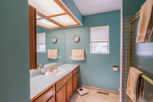 402 2nd Ave SE, Mapleton, MN 56065 - full bath featuring healthy amount of natural light, vanity, tile patterned floors, and an enclosed shower