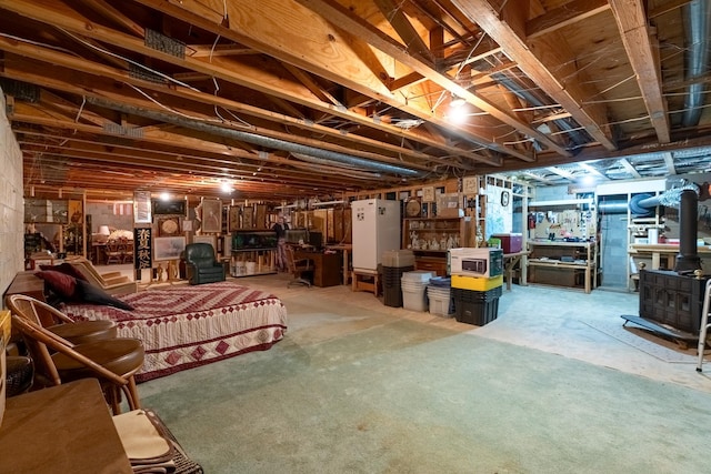 402 2nd Ave SE, Mapleton, MN 56065 - unfinished below grade area featuring a wood stove
