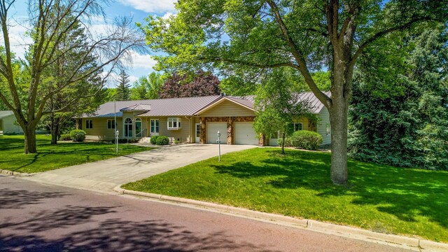 402 2nd Ave SE, Mapleton, MN 56065 - ranch-style home with a garage, a front yard, driveway, metal roof, and a standing seam roof