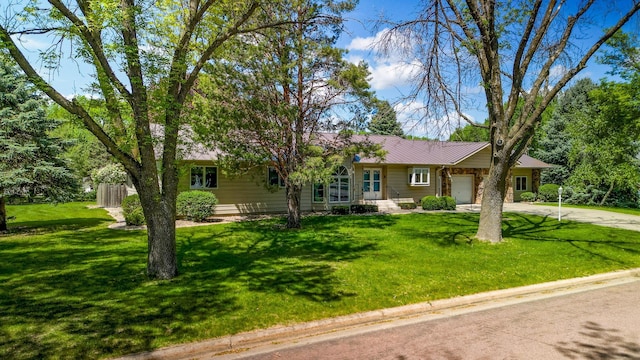 402 2nd Ave SE, Mapleton, MN 56065 - ranch-style house featuring an attached garage, driveway, a front lawn, and metal roof