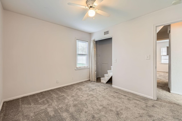 unfurnished bedroom featuring carpet floors, baseboards, and ceiling fan