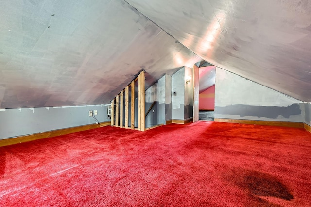 bonus room featuring lofted ceiling, baseboards, and carpet flooring
