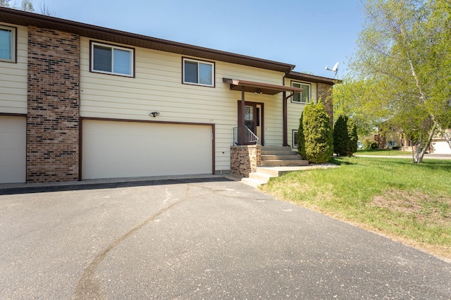 1346 Latoka Drive Ct SW, Alexandria, MN 56308 - split foyer home featuring a garage, asphalt driveway, brick siding, and a front yard