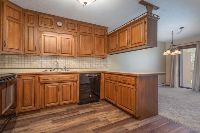 1346 Latoka Drive Ct SW, Alexandria, MN 56308 - kitchen with black appliances, light countertops, brown cabinets, a peninsula, and a textured ceiling
