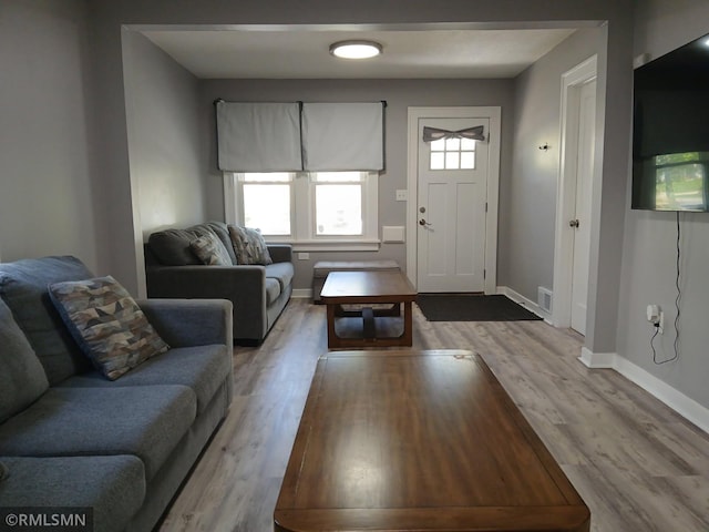 living area with wood finished floors and baseboards
