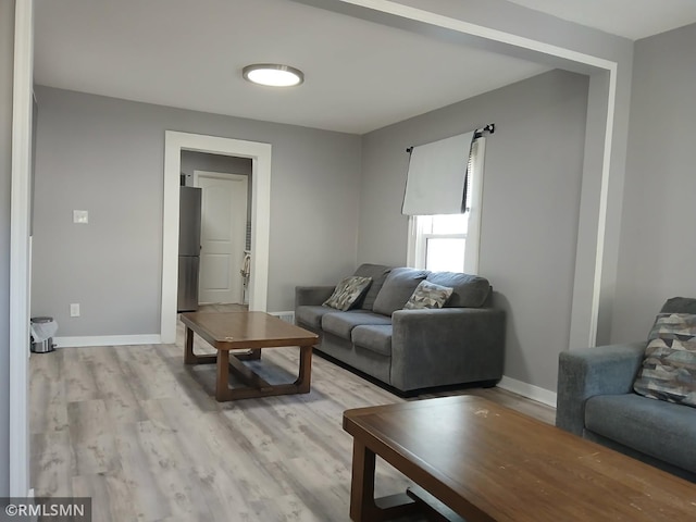 living room with light wood finished floors and baseboards