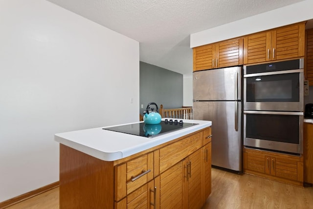 20441 Elmwood Rd, Lynden Twp, MN 55320 - kitchen with stainless steel appliances, light wood finished floors, and brown cabinetry