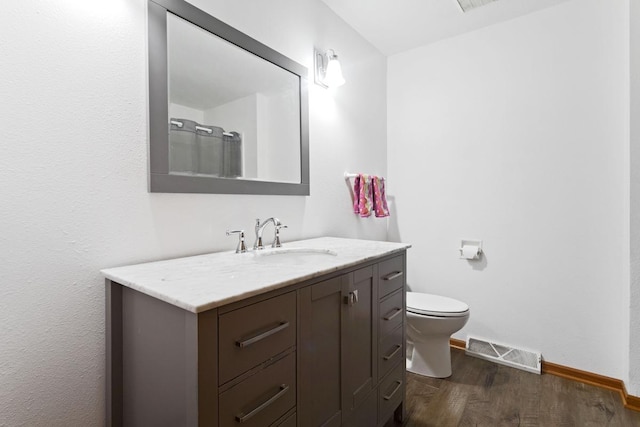 20441 Elmwood Rd, Lynden Twp, MN 55320 - bathroom featuring wood finished floors, vanity, baseboards, toilet, and a shower