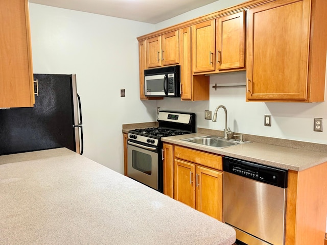 3116 12th Ave S Unit A209, Minneapolis, MN 55407 - kitchen with appliances with stainless steel finishes, a sink, light countertops, and brown cabinets