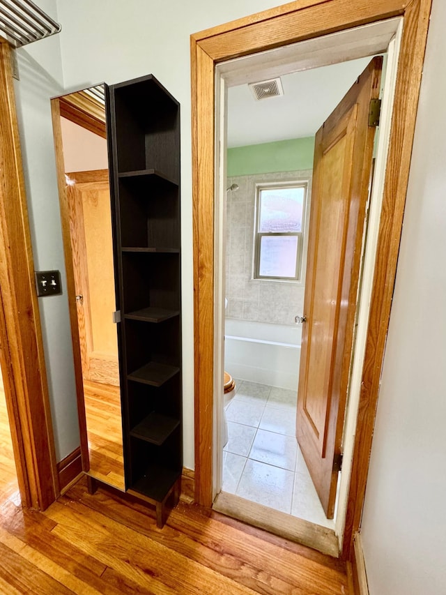 3116 12th Ave S Unit A209, Minneapolis, MN 55407 - hallway featuring wood finished floors and baseboards