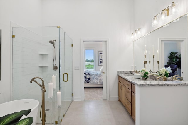 4549 Tovero Trl, Medina, MN 55340 - bathroom with ensuite bathroom, a stall shower, double vanity, a freestanding bath, and baseboards