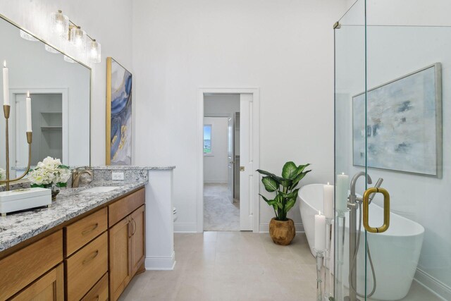4505 Tovero Trl, Medina, MN 55340 - full bath featuring double vanity, baseboards, and a freestanding bath