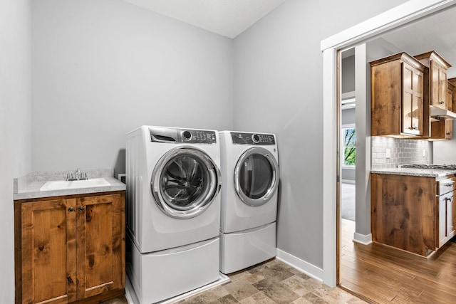 18041 224th Ave NW, Big Lake Twp, MN 55309 - laundry area featuring washing machine and dryer, cabinet space, and baseboards