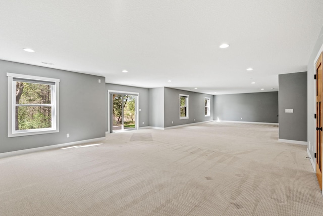 18041 224th Ave NW, Big Lake Twp, MN 55309 - unfurnished living room with light carpet, recessed lighting, and baseboards