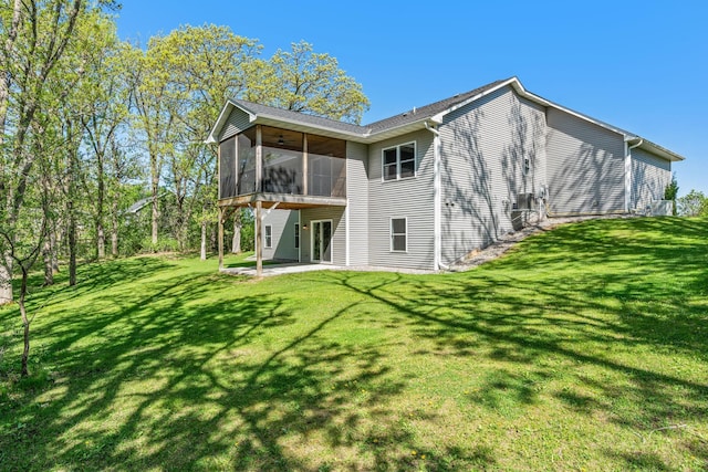 18041 224th Ave NW, Big Lake Twp, MN 55309 - rear view of property with a sunroom, a patio, and a yard