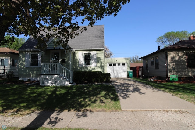 view of front facade featuring a garage, concrete driveway, and a front yard