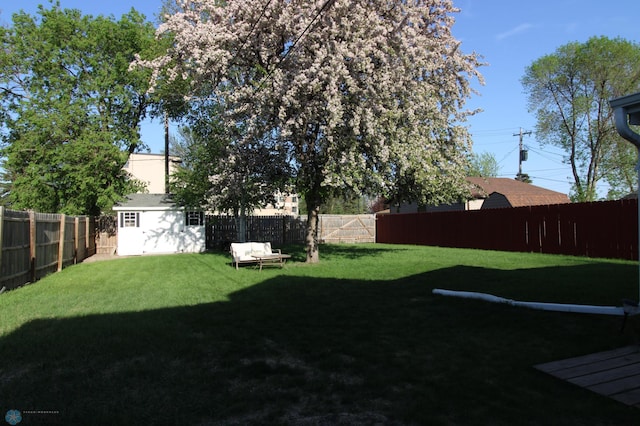 view of yard with an outdoor structure and a storage unit