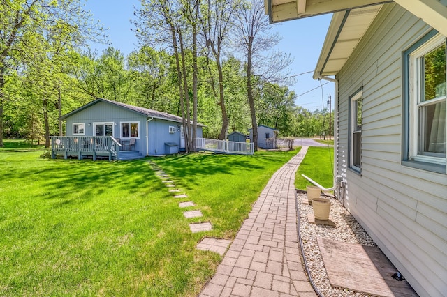 23620 Melissa Dr, Lake View Twp, MN 56501 - view of green lawn with a deck and an outdoor structure