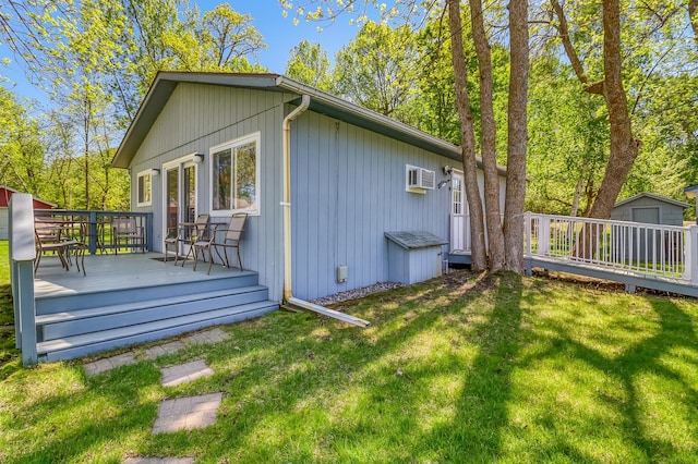 23620 Melissa Dr, Lake View Twp, MN 56501 - view of side of property with a wooden deck, a shed, a lawn, an outdoor structure, and a wall unit AC