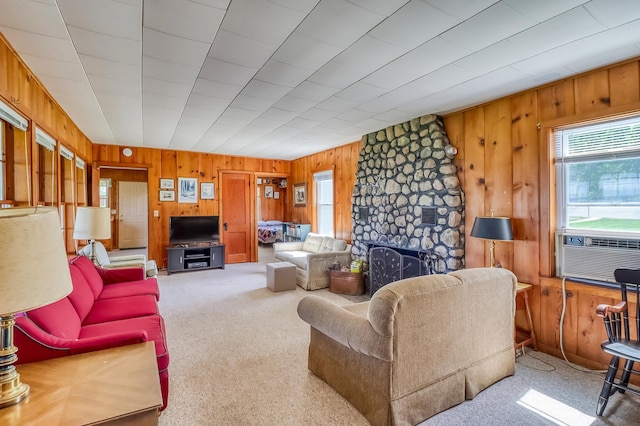 23620 Melissa Dr, Lake View Twp, MN 56501 - living room featuring wooden walls, carpet flooring, a stone fireplace, and cooling unit