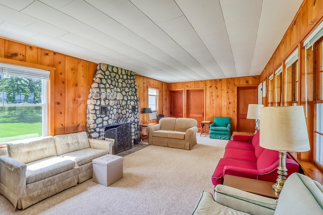 23620 Melissa Dr, Lake View Twp, MN 56501 - living room with carpet flooring, wooden walls, and a stone fireplace