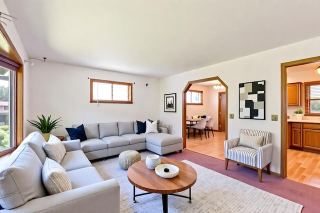 5391 Cottage Ave, White Bear Twp, MN 55110 - living room featuring arched walkways and light wood finished floors