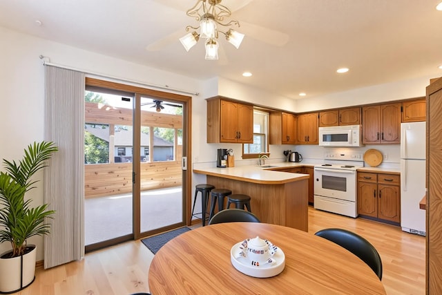 5391 Cottage Ave, White Bear Twp, MN 55110 - kitchen with white appliances, light wood-style floors, a ceiling fan, light countertops, and recessed lighting
