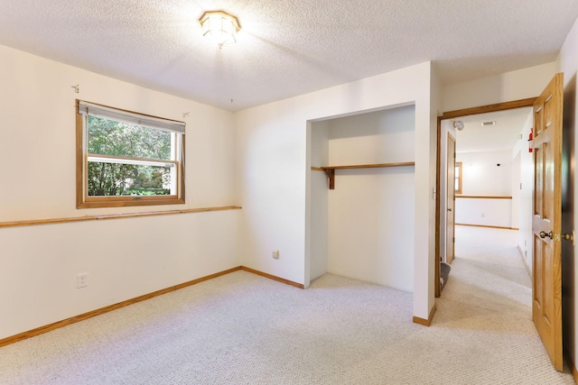 5391 Cottage Ave, White Bear Twp, MN 55110 - unfurnished bedroom featuring light colored carpet, a textured ceiling, and a closet