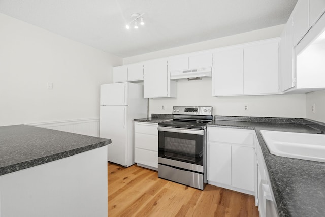 9018 Neill Lake Rd, Eden Prairie, MN 55347 - kitchen with electric stove, freestanding refrigerator, under cabinet range hood, a sink, and dark countertops