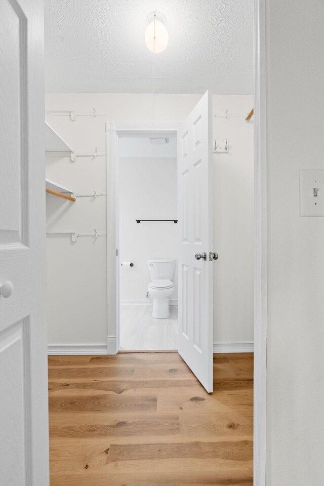 9018 Neill Lake Rd, Eden Prairie, MN 55347 - walk in closet with wood finished floors