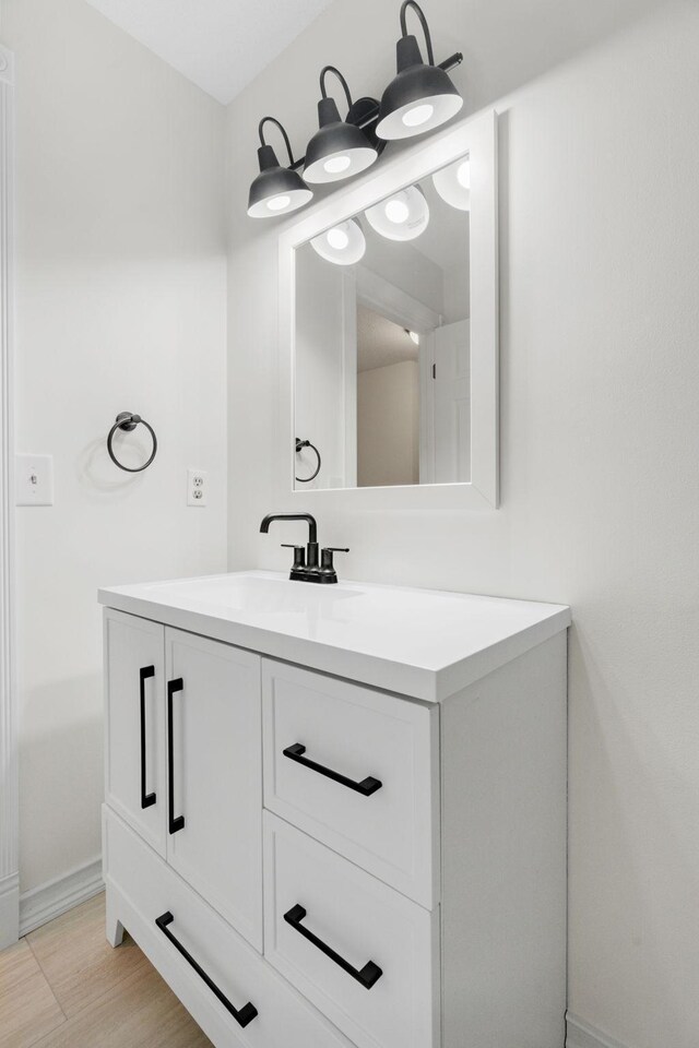 9018 Neill Lake Rd, Eden Prairie, MN 55347 - bathroom featuring baseboards and vanity