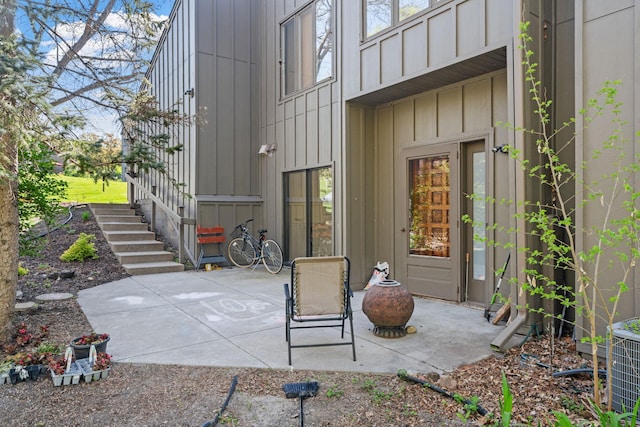 9018 Neill Lake Rd, Eden Prairie, MN 55347 - doorway to property with board and batten siding, a patio, and central AC