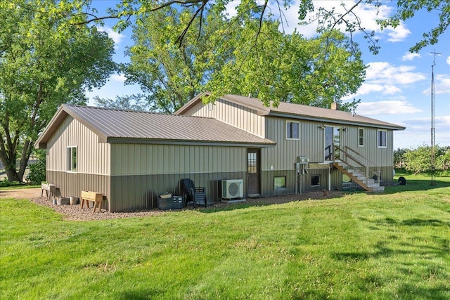 E7065 County Road B, Tainter Twp, WI 54730 - rear view of property featuring a lawn, a cooling unit, and metal roof