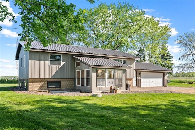 E7065 County Road B, Tainter Twp, WI 54730 - rear view of house featuring a garage, driveway, a lawn, and brick siding