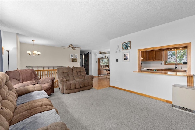 E7065 County Road B, Tainter Twp, WI 54730 - living area featuring carpet flooring, a chandelier, a ceiling fan, baseboards, and a textured ceiling