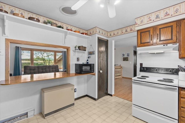 E7065 County Road B, Tainter Twp, WI 54730 - kitchen featuring under cabinet range hood, white range with electric cooktop, black microwave, brown cabinets, and a ceiling fan