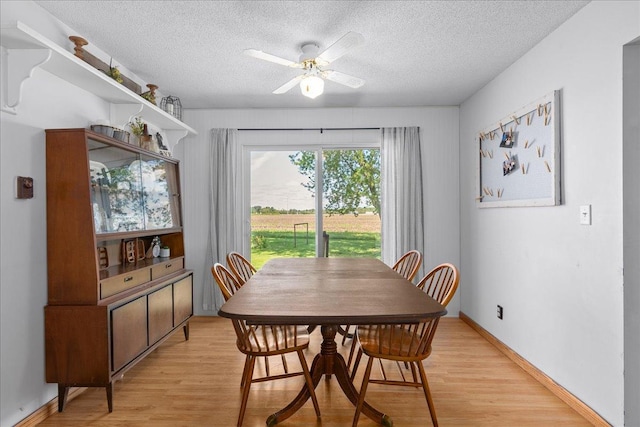 E7065 County Road B, Tainter Twp, WI 54730 - dining space featuring a textured ceiling, light wood-type flooring, and ceiling fan