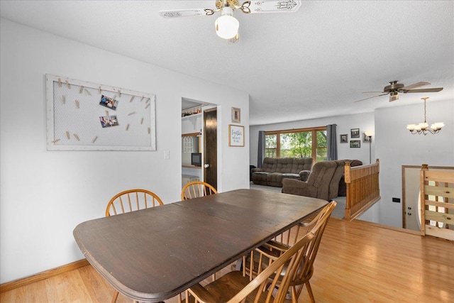 E7065 County Road B, Tainter Twp, WI 54730 - dining room featuring ceiling fan, light wood finished floors, a textured ceiling, a chandelier, and baseboards