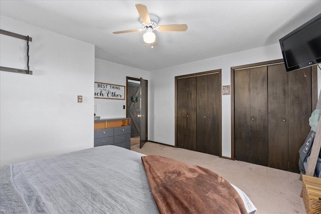E7065 County Road B, Tainter Twp, WI 54730 - bedroom with two closets, light colored carpet, and a ceiling fan