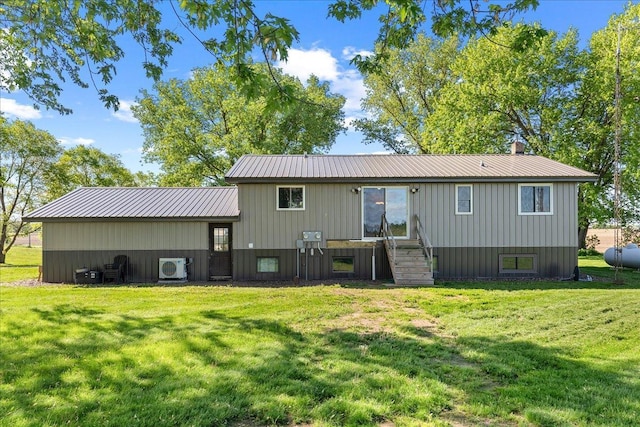 E7065 County Road B, Tainter Twp, WI 54730 - rear view of house featuring a cooling unit, a lawn, metal roof, and board and batten siding