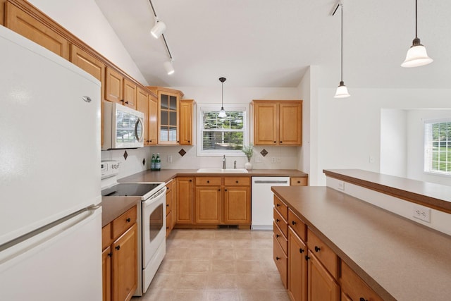 574 Marsh Dr, Delano, MN 55328 - kitchen with white appliances, a sink, track lighting, pendant lighting, and tasteful backsplash