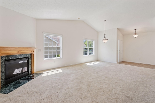 574 Marsh Dr, Delano, MN 55328 - unfurnished living room with a premium fireplace, carpet flooring, vaulted ceiling, and baseboards